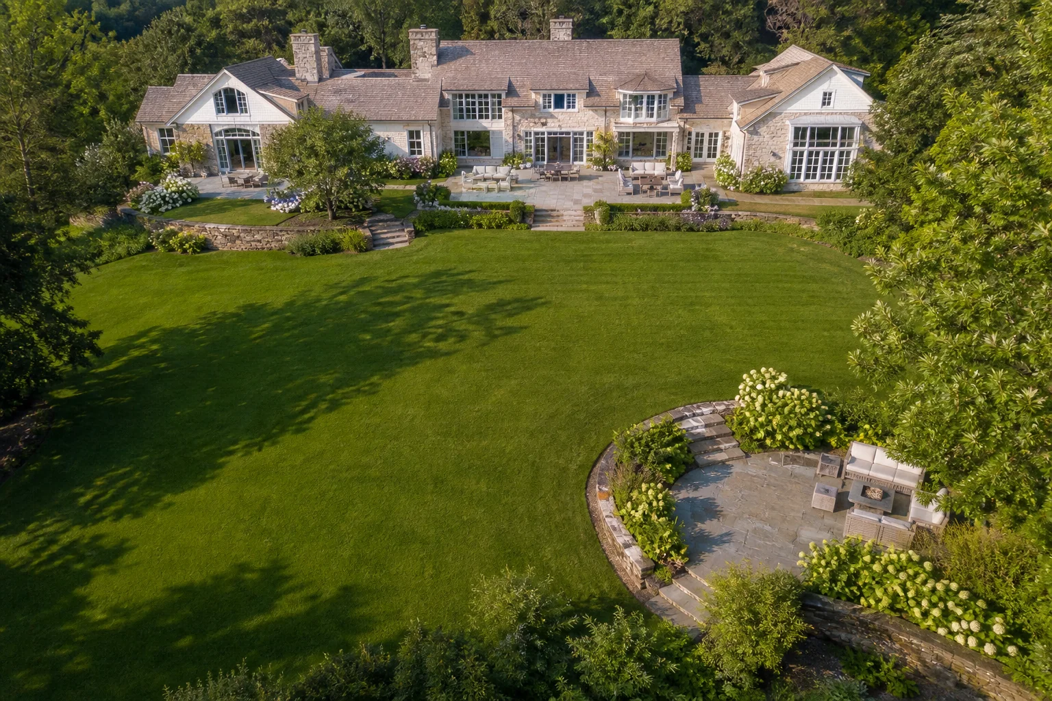 Aerial drone view of a luxury New York estate lawn before pool construction
