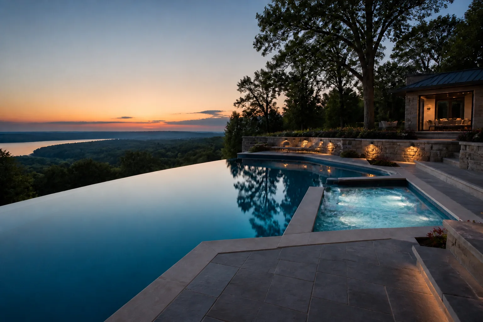Infinity-edge gunite pool at dusk with active spa water